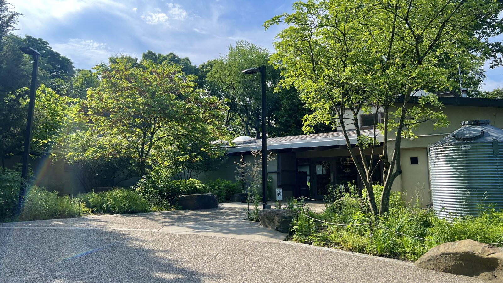 The front door of the Schuylkill Center and the front gardens on a bright summer day.