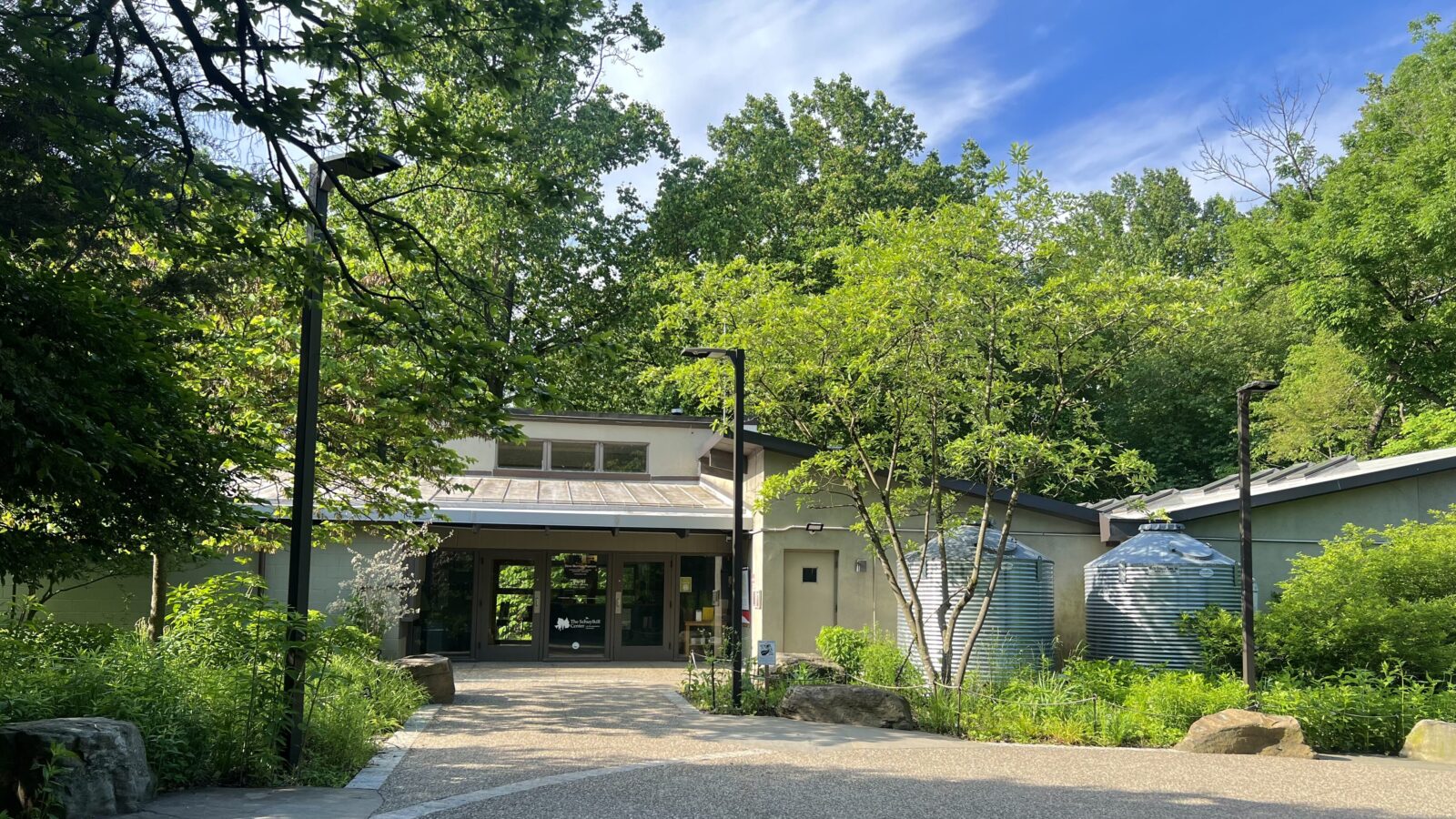 The front door of the Schuylkill Center and the front gardens on a bright summer day.