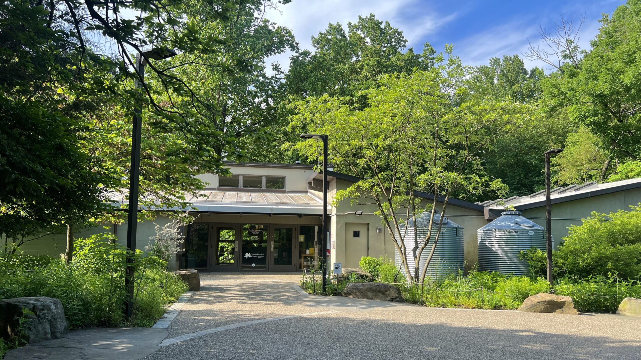 The front door of the Schuylkill Center and the front gardens on a bright summer day.